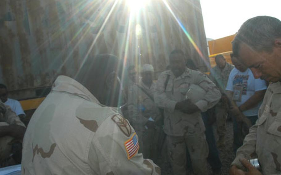 Troops of the 1052nd Transportation Company, a National Guard unit out of Kingstree, S.C., along with truck drivers from Kellogg, Brown & Root, pray together before heading out to Baghdad. Nerves are especially high Monday because there was an attack that had mass casualties along the same supply route near Taji only a couple of days earlier.