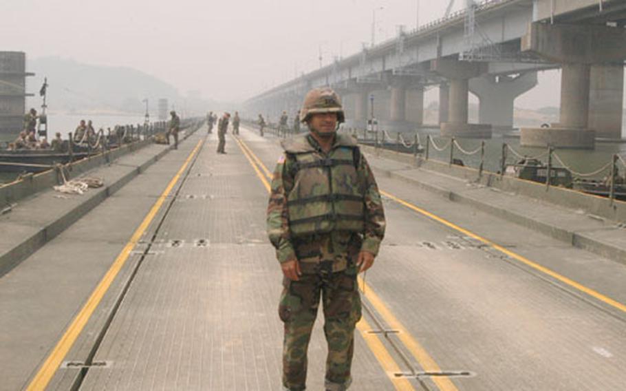 Captain David Stewart, Commander of the 2nd Infantry Division&#39;s 50th Engineers Company, stands on a floating bridge built by U.S. and South Korean engineers over the Han River on Thursday.