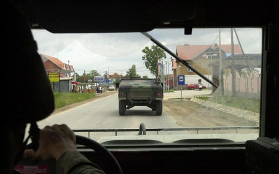 Spc. Matthew Vander Plas drives a Humvee along the road between Camp Bondsteel and the city of Vitina in Kosovo last week, following behind the lead vehicle in the patrol. American soldiers have been in the province five years now, though their mission has largely disappeared from international attention due to the missions in Iraq and Afghanistan.