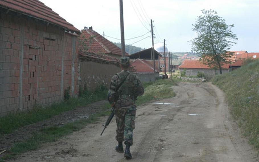 Spc. Anthony Duong takes the point Tuesday on a patrol through a Kosovo village conducted by members of the Iowa National Guard. American troops and allied countries have had soldiers in the province for five years now. The peacekeeping mission continues, though the world&#39;s attention has clearly shifted to operations in the Middle East.