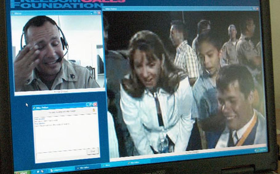 Staff Sgt. Jacques Rodriguez, with Company A, 185th Corps Support Command, upper left, wipes a tear while talking to his family in California using new high-speed video teleconference equipment available at Camp Cooke, Iraq.