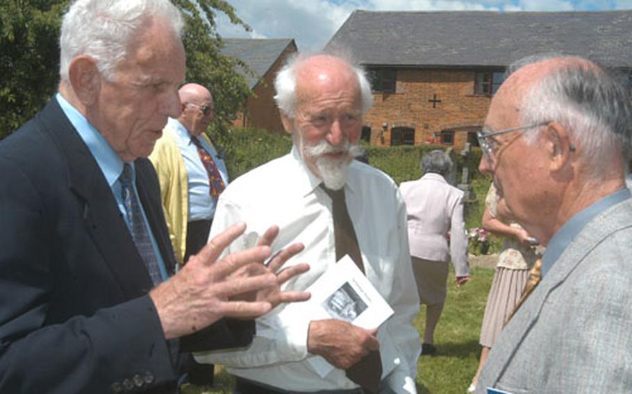 Keith Anderson, left, and Russell Reed, right, former B-17 pilots with the 398th Bomb Group, talk about flying with Mike Graty, center, who flew Lancaster bombers for the Royal Air Force during World War II. The three men talked after a service of thanksgiving at St. George&#39;s Church in Anstey, England, honoring the men of the 398th who died in the war.