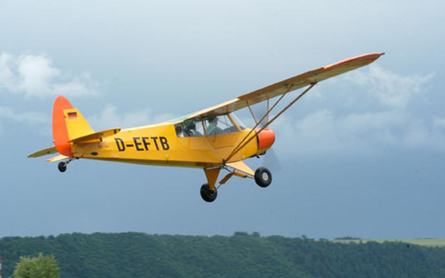 A Piper J-3 Cub, a training plane for American pilots in World War II, takes off Saturday at the Mont Royal Airfield Saturday near Traben-Trarbach, Germany.