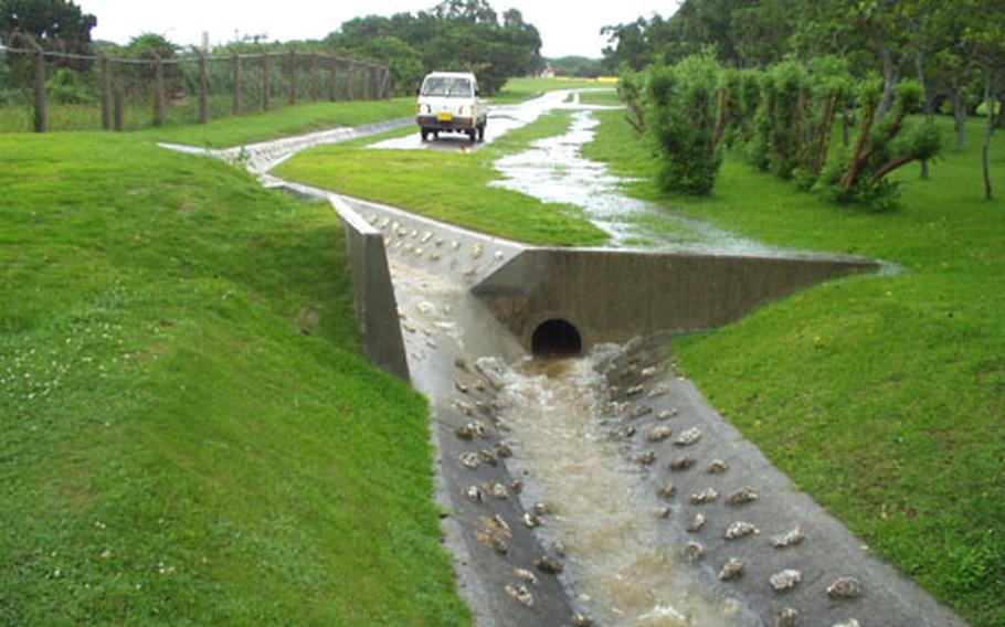 Before this culvert was installed along the Marine Corps Air Station Futenma baseline, water would run into a local elementray school&#39;s basement.