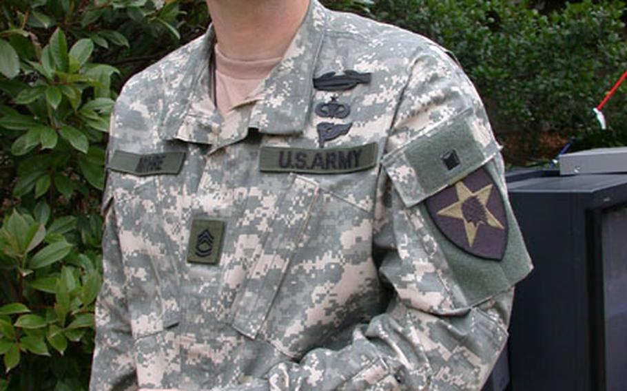 The top half of the new Army BDUs has a zipper rather than buttons. Note the changed placement of the rank, which will move from over the nametape to the center front, and the pen-and-pencil pockets on the right-hand sleeve, located on the forearm of the left sleeve.