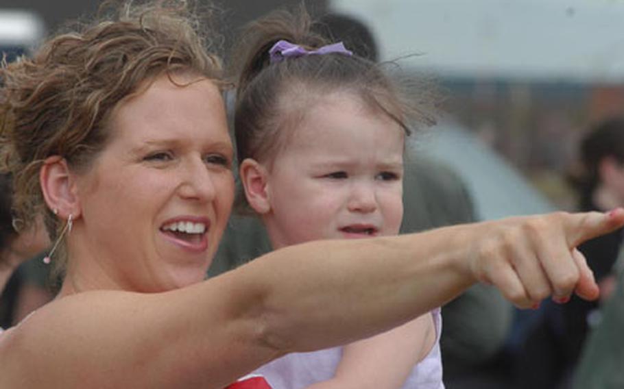 Darci Beatty points out "Capt. Daddy" to her daughter, Elliana, Wednesday afternoon at RAF Lakenheath, England. Capt. John Beatty, called "Capt. Daddy" by Elliana, was in one of six F-15E Strike Eagles from the 48th Fighter Wing that returned from a three-month deployment to the Middle East.