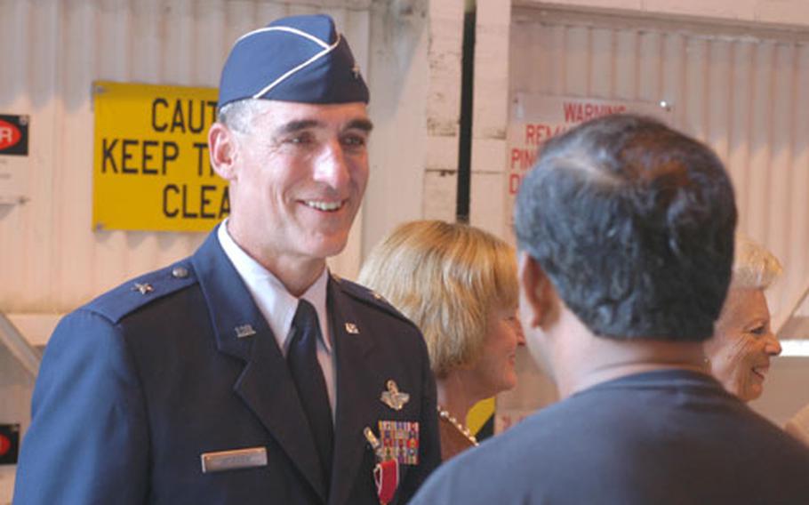 Brig. Gen. Mike Worden, the outgoing commander of the 31st Fighter Wing at Aviano Air Base, says farewell to a long line of well-wishers after Worden gave up command of the wing Friday.