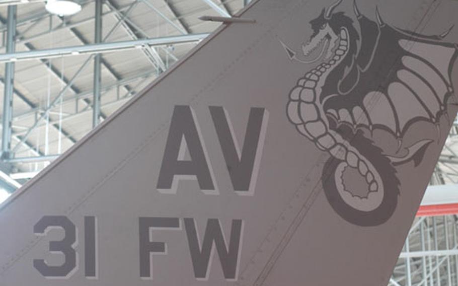 The tail of the F-16 dubbed the "flagship" of the 31st Fighter Wing displays the dragon mascot while parked in a hangar on Aviano Air Base, Italy, during the wing&#39;s change-of-command ceremony Friday.