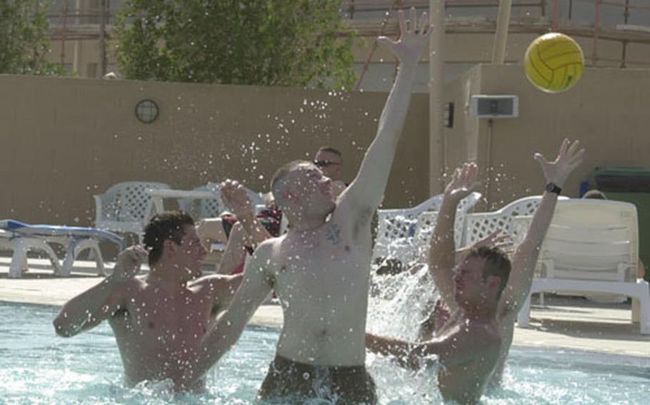 Members of the Army National Guard&#39;s 45th Infantry Brigade, based out of Oklahoma, play in the pool at Camp As Sayliyah, Qatar. The unit is currently serving in Afghanistan, but these troops were able to get away for four days of fun provided through the Fighter Management Pass Program.