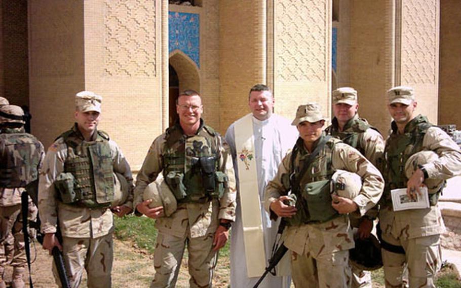 Chaplain (Capt.) Ken Beale (center) says troops apologize to him because he goes into harm&#39;s way to deliver Mass. With a shortage of Catholic chaplains, he performs Mass on Wednesdays, Thursdays, Fridays and Saturdays.
