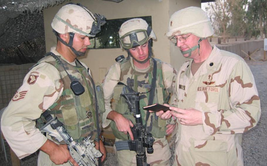 Chaplain (Lt. Col.) Frank Yerkes, right, confers with Staff Sgt. Matthew Molton, left, and Senior Airman Jeffery George in Baghdad, both members of the 824th Security Forces Squadron from Moody Air Force Base, Ga.