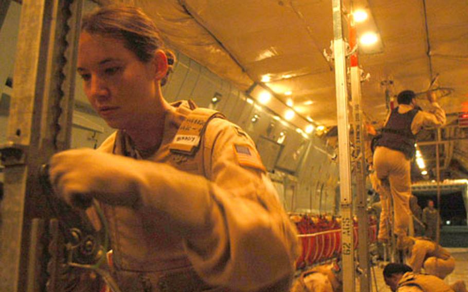Air Force Capt. Kimberly Brady and her crew of medics prepare a C-141 Starlifter to carry wounded patients from Iraq to Germany.