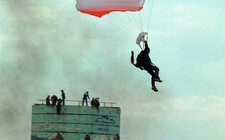 A paratrooper glides in during a NATO simulation of a search-and-rescue operation resulting from a chemical leak in Noginsk, Russia, in 2002. This week Russia hosts another NATO disaster exercise, this time in Kaliningrad, to drill in case of an attack on an oil platform.