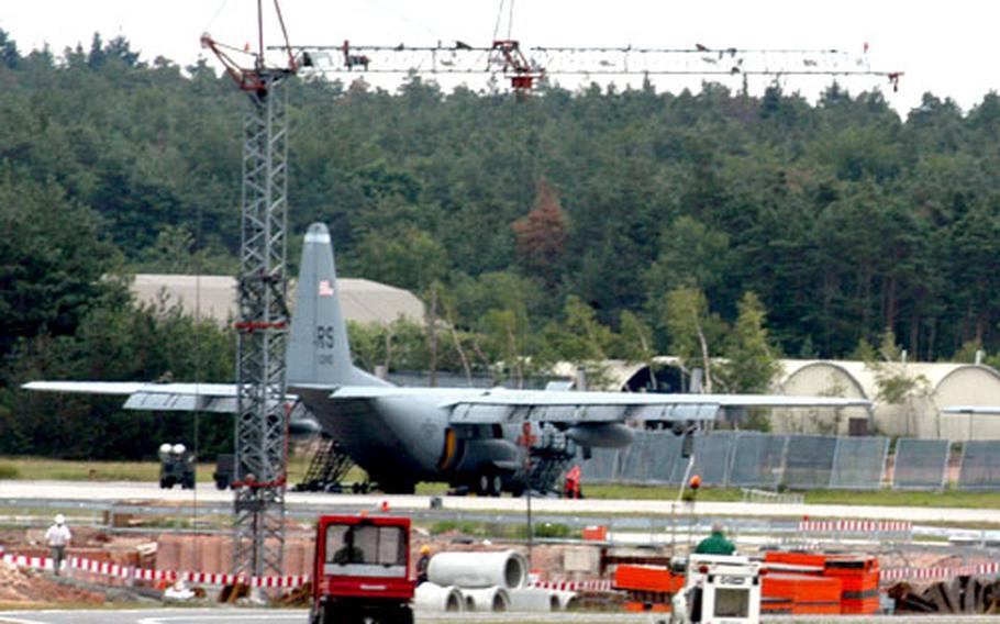 An Air Force C-130 sits near a water-retention basin being built at Ramstein Air Base, Germany. Base airfield management airmen are keeping the air traffic at full volume while the base undergoes massive construction to get ready for the transition from Rhein-Main Air Base to Ramstein next year.