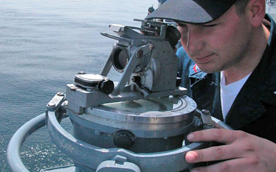Petty Officer 3rd Class Darrell Crawford looks through a gyrocompass repeater on the starboard bridgewing of the Russian frigate Neustrashimy. The repeater is used to determine another ship&#39;s direction in relation to that of the observer&#39;s ship.