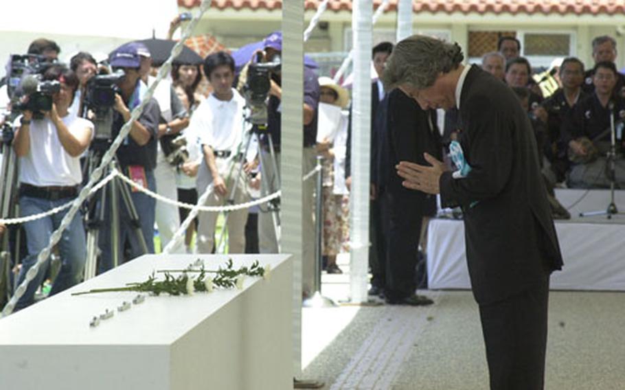 Junichiro Koizumi, the prime minister of Japan, bows in respect and says a prayer during a ceremony Wednesday at the Okinawa Memorial Peace Park in Itoman, commemorating the more than 200,000 men and women who died in the Battle of Okinawa.