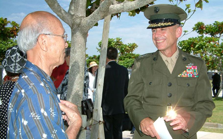 Lt. Gen. Robert R. Blackman, commander Marine Corps Bases Japan, speaks with Ralph Tsuha, 80, a Japanese-American who served as a translator with the American invasion force during the Battle of Okinawa. Tsuha and many other Nisei settled on Okinawa after the war.