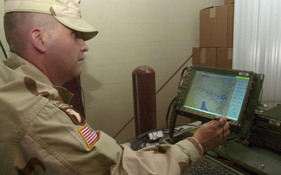 Army Maj. Michael Martyn, Blue Force Tracker program manager, demonstrates the system&#39;s capabilities by showing equipped vehicles currently on the ground in Iraq. Martyn pulled them up on the screen from a warehouse on Camp Arifjan, Kuwait.