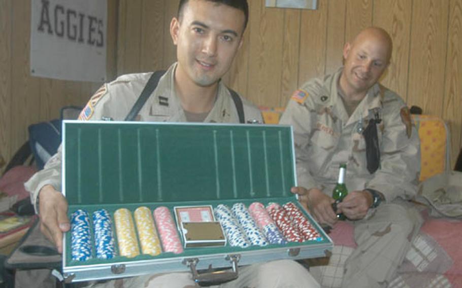 Capt. David "KGZ" Zimmerman, medical operations officer for Headquarters and Headquarters Company, 1st Cavalry Division, displays a tray of poker chips given to the troops from oldvegaschips.com. The chips were once used in a fund-raising event before they were donated to the 1st Cav soldiers.
