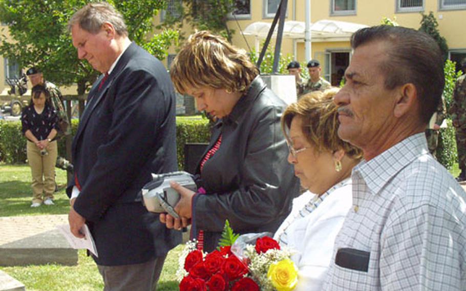 From left, Ron Smith, Veronica Valadez, and Orelia and Ramiro Gonzalez, stand for a moment in front of a monument dedicated to their loved ones who were killed in a helicopter crash in Kuwait in February 2003.