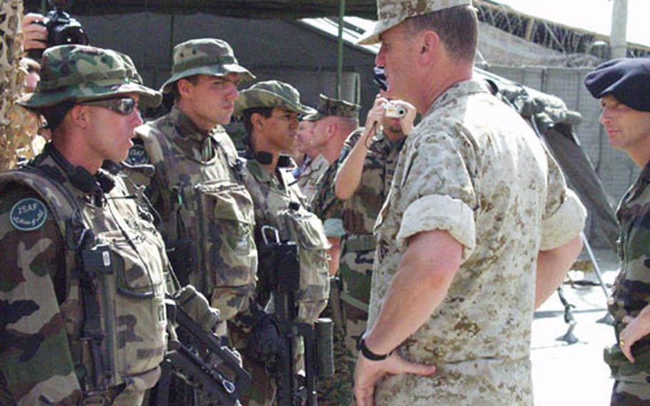 Gen. James L. Jones, supreme allied commander of NATO military forces, right, inspects French troops at Kabul International Airport.