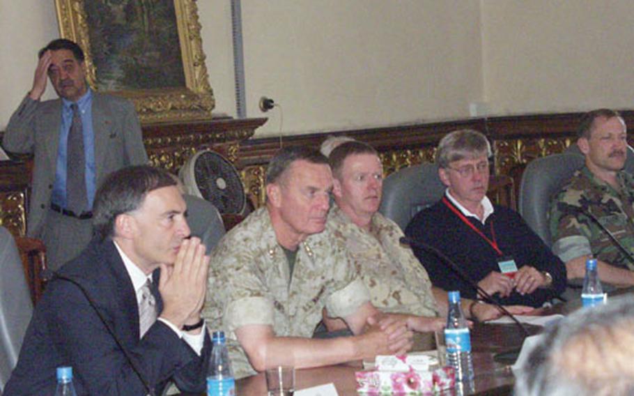 Gen. James L. Jones, second from left, discusses NATO troop increases with Afghan and international officials.