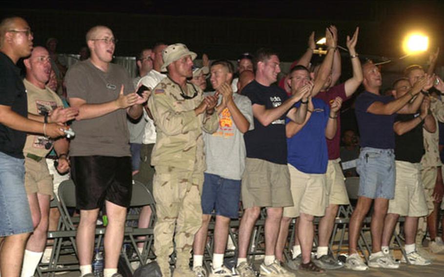 Troops on Camp Arifjan, Kuwait, give the Baltimore Ravens cheerleaders a standing ovation after their performance Wednesday evening.