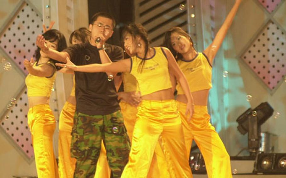 A South Korean soldier performs a song, with backup dancers, during the "Young Soldiers" entertainment show put on at bases throughout the country.