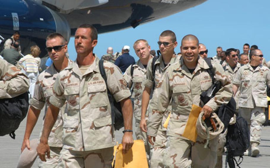 Misawa Air Base, Japan, servicemembers disembark from a 757 jet in front of Hangar 949 on Saturday after a three-month deployment to Iraq. More than 70 people returned home on a chartered flight.