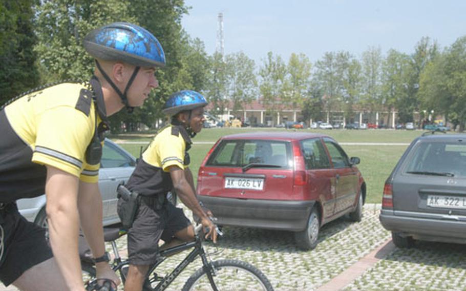 Military policemen Nathan Brumley, left, and Cyril Illidge begin their bicycle patrol on Caserma Ederle in Vicenza, Italy, on Thursday. The military has found at bases such as Vicenza that police on bikes often are able to get around easier and communicate more with the base population.