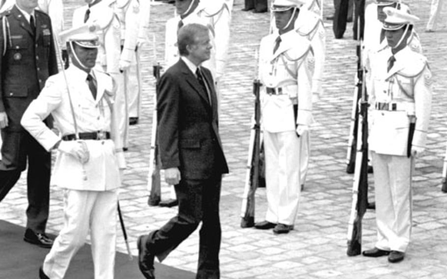 President Jimmy Carter troops the line of the honor guard at Akasaka Palace, where he was to meet with Emperor Hirohito, in June, 1979.