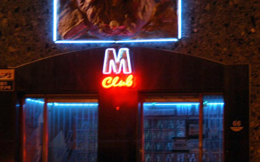 The M-Club in Toka-ri, South Korea, is one of many bars and brothels displaying 2nd Infantry Division symbols, such as a huge Indianhead — the division&#39;s logo — above the door.