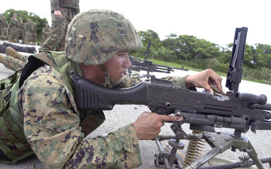 Cpl. Raymond Terlaje, a Stinger gunner with the 31st Marine Expeditionary Unit, loads rounds into an M240G machine gun training on Range 8 on Okinawa.