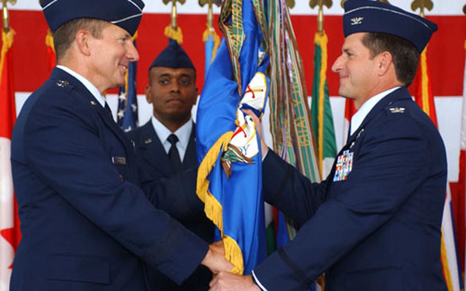 Maj. Gen. Michael C. Gould, left, 3rd Air Force commander, passes the 52nd Fighter Wing guidon to the new commander, Col. David Goldfein at the ceremony Friday at Spangdahlem Air Base, Germany.