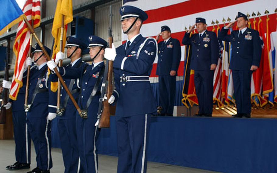 The color guard presents the colors Friday at a change of command ceremony at Spangdahlem Air Base, Germany. In the background are, from left, Maj. Gen. Michael C. Gould, 3rd Air Force commander; Col. Stephen Mueller, the outgoing commander of the 52nd Fighter Wing; and Col. David Goldfein, the wing&#39;s new commander.