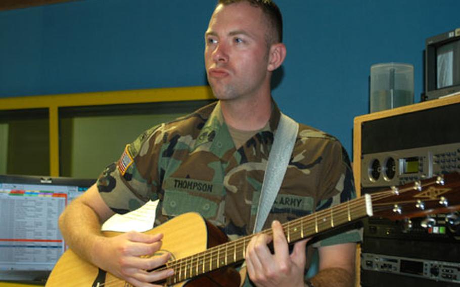 Staff Sgt. Joe Thompson, AFN Hessen noncommissioned officer in charge, jams out on his guitar in the radio studio Thursday in Wiesbaden, Germany. GI Joe, as he&#39;s known on the air, has been playing guitar for over ten years and is regular entertainment at a German pub near Frankfurt.