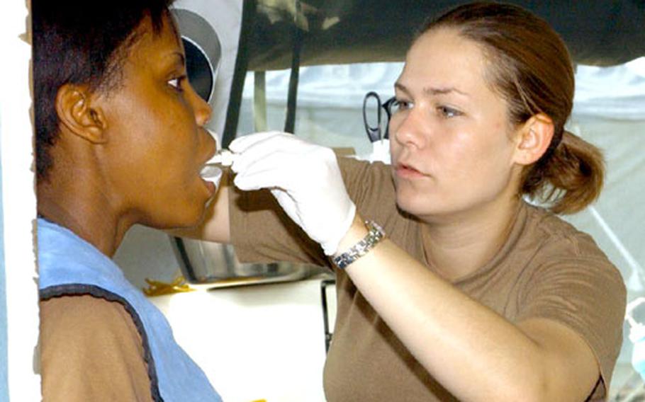 Spc. Bridget McClure prepares Spc. Erica Morgan for an X-ray before removal of her wisdom teeth Saturday at the Bulwark &#39;04 exercise at the Novo Selo Training Area, Bulgaria.