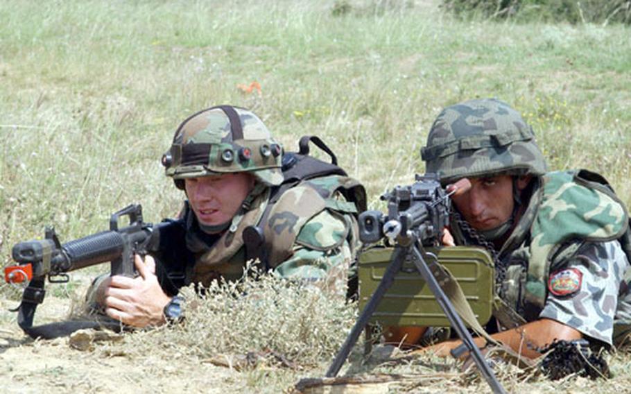 Staff Sgt. Jeremy Wenthe, left, and Bulgarian soldier Pvt. Atanas Kovachev train side by side during a Multi Operations Urban Training exercise Wednesday at the Novo Selo Training Area, Bulgaria. Twenty-two Bulgarian troops trained with U.S. soldiers during the Bulwark &#39;04 exercise.