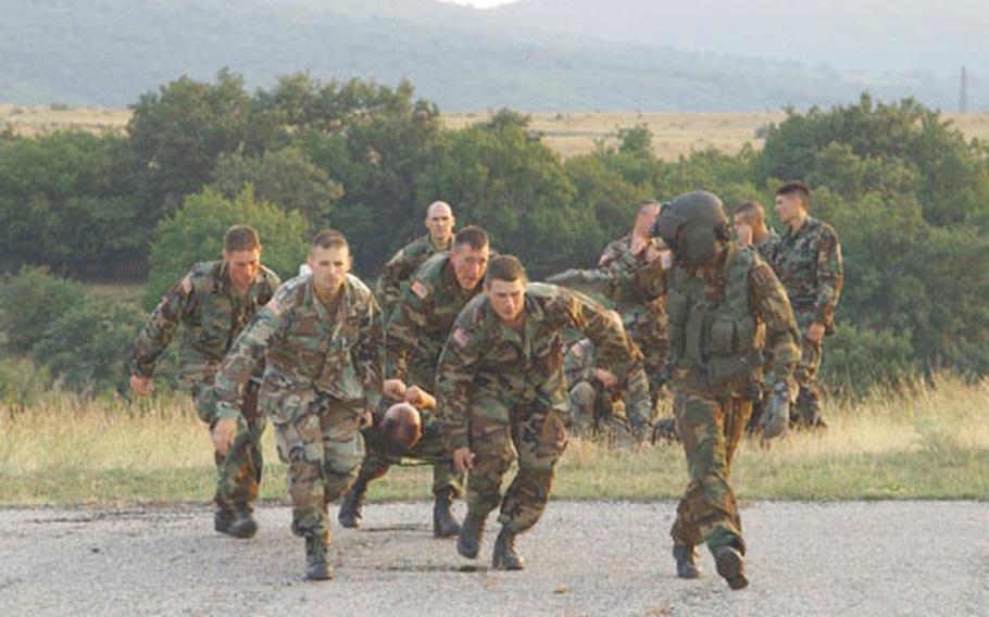 Members of the 130th Infantry Regiment of the Illinois National Guard learn how to load a litter patient onto a helicopter during a class Tuesday taught by the 236th Medical Company (Air Ambulance) crew out of Landstuhl, Germany, at Bulwark &#39;04 at the Novo Selo Training Area, Bulgaria.