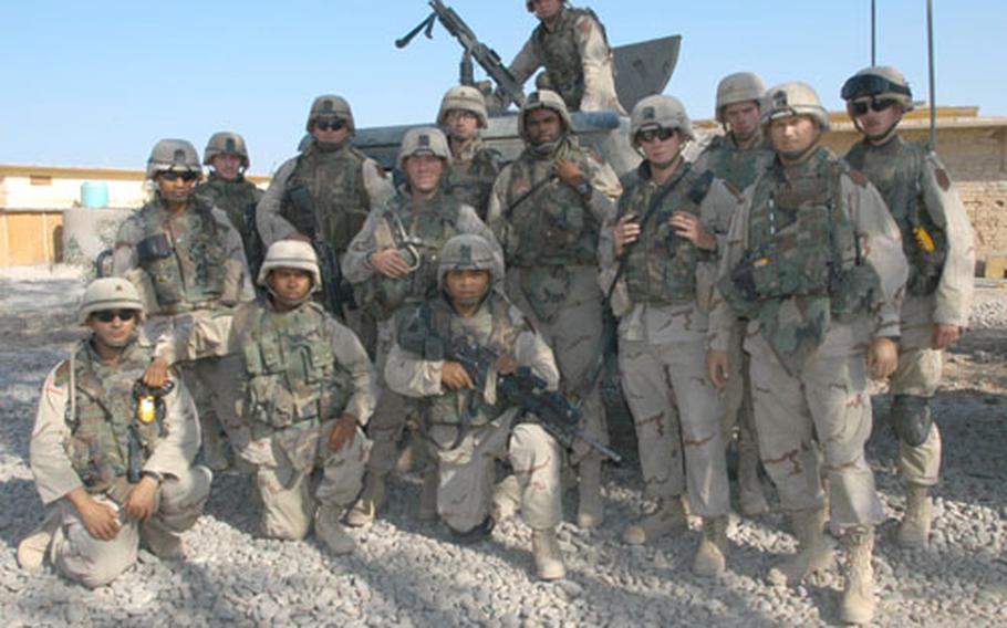 The "Renegades" from 3rd Platoon, Battery B, 1st Battalion, 6th Field Artillery Regiment, pose in front of the lead vehicle Tuesday before going out on a mission in Baqouba, Iraq.