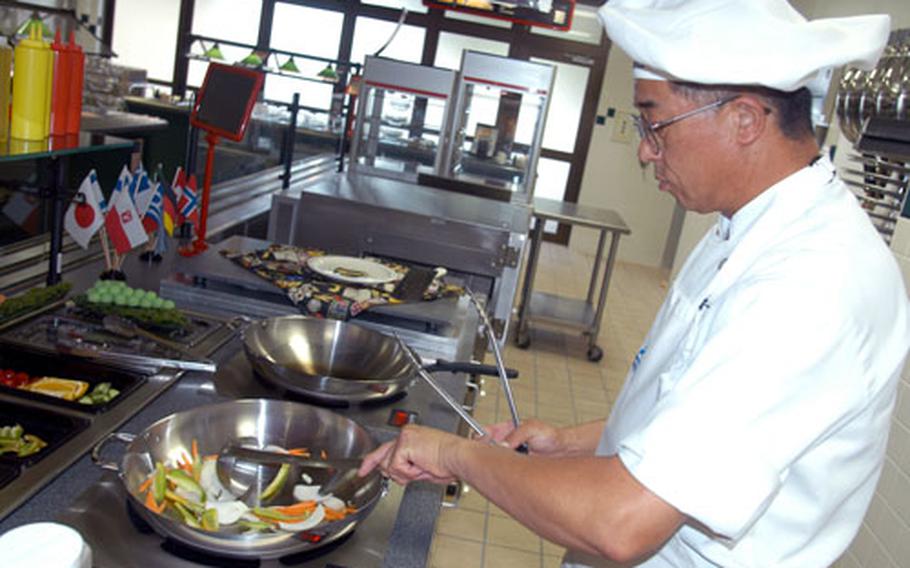 Head chef Ebina Takeshi whips up some Mongolian barbecue at Grissom Dining Facility&#39;s new wok station.