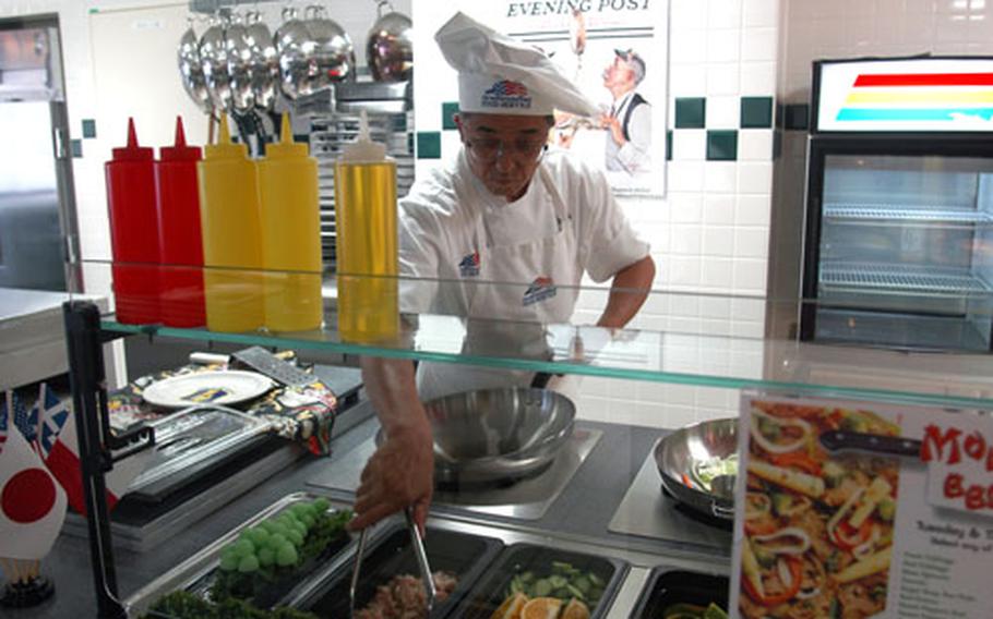 Head chef Ebina Takeshi whips up some Mongolian barbecue at Grissom Dining Facility&#39;s new wok station. The mess hall for enlisted airmen at Misawa Air Base, Grissom reopens Aug. 16 after a $600,000 renovation project to upgrade and expand its serving area and food selections.