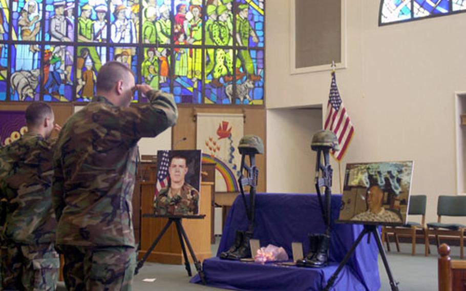 Colleagues of Capt. Kevin M. Norman and CW3 David W. Snow pay their final respects at a memorial service for the pilots, who were killed in a 2003 crash near Camp Humphreys, South Korea.