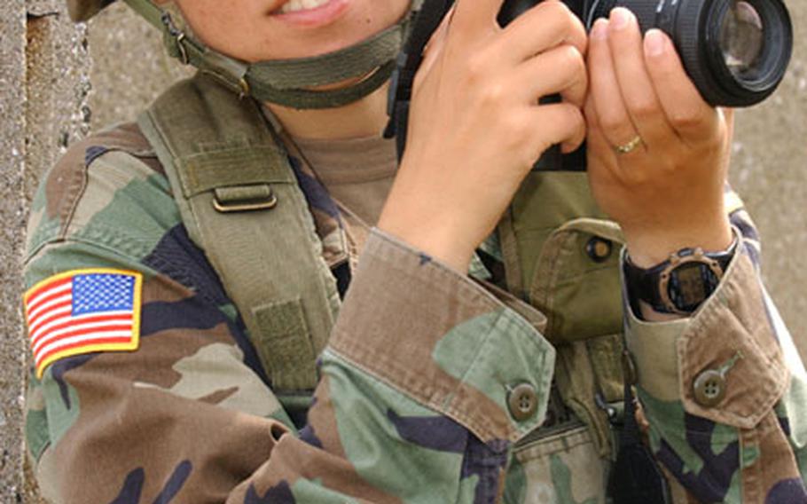 Sgt. Teodora Mocanu shoots photos, not weapons, at the Military Operations Urban Terrain course during Bulwark &#39;04 at the Novo Selo Training Area, Bulgaria.