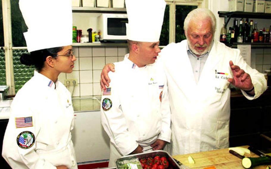 Master Chef Karl-Heinz Dickheiwer, right, imparts cooking secrets to Sgt. Scott Graves, center, while Spc. Luisa Conception listens in Tuesday morning at La Cachette restaurant. Graves and Conception earned the right to study with Dickheiwer by being selected as Army senior and junior chefs of the year, respectively.