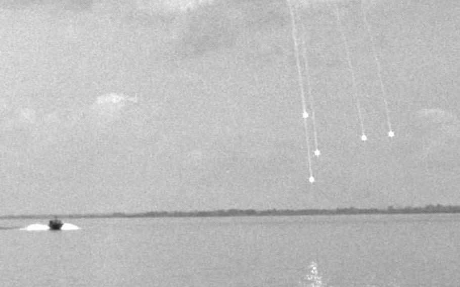 Flares are fired by an MP river patrol boat, approaching at left, to salute comedian Joey Bishop, foreground.