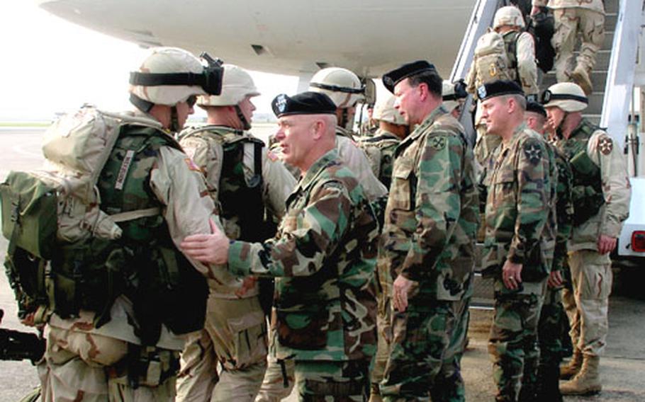 On Tuesday at Osan Air Base, troops of the Army&#39;s 2nd Infantry Division&#39;s Strikeforce brigade board a jetliner for Kuwait and eventual duty in Iraq. Seeing them off is Gen. Leon J. LaPorte, the top American commander in South Korea. To LaPorte&#39;s right are Lt. Gen. Charles C. Campbell, commander of 8th U.S. Army, and Maj. Gen. John R. Wood, commander of the 2nd Infantry Division.