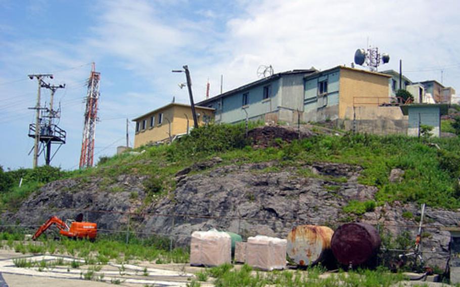 These are some of the structures set for demolition at a U.S. Army radio site atop a mountain near Kumi City in lower South Korea. The 36th Signal Battalion is upgrading its communications equipment at the site, and an Army helicopter had to airlift construction equipment to the peak Monday because the mountain has no roads to the top.
