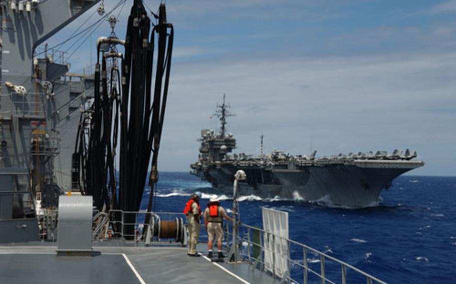 USS Kitty Hawk makes its approach to the oiler USNS Yukon to commence a replenishment-at-sea.