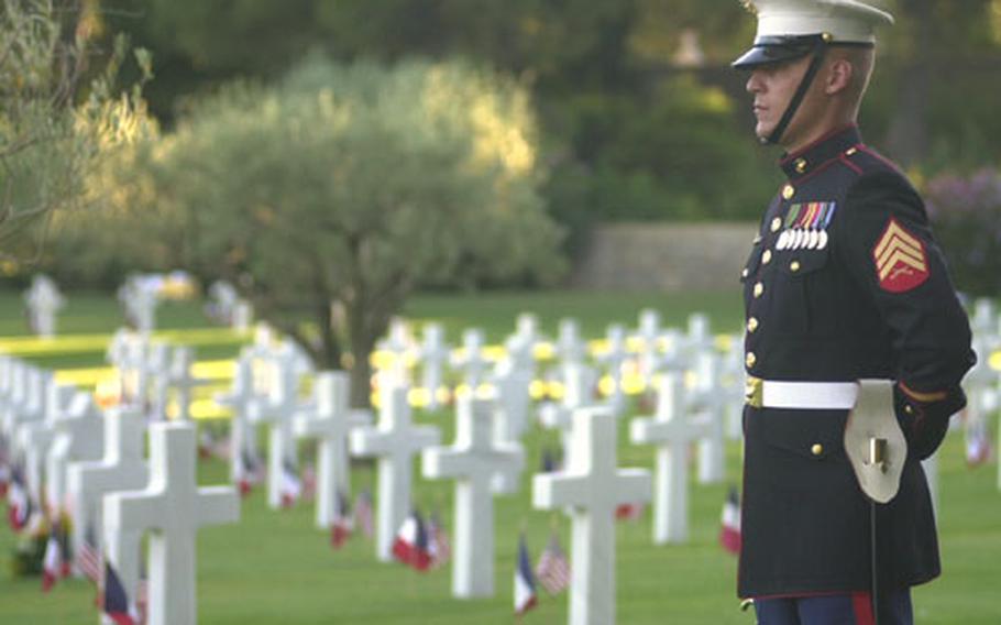 A U.S. Marine stands besides rows of graves at Rhone American Cemetery in Draguignan, France. About 1,500 Americans and French on Saturday evening commemorated the 60th anniversary of the Allied landing in southern France. (enw# 61p pp)